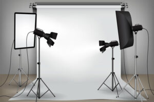 Realistic photo studio set up with lighting equipment and white backdrop